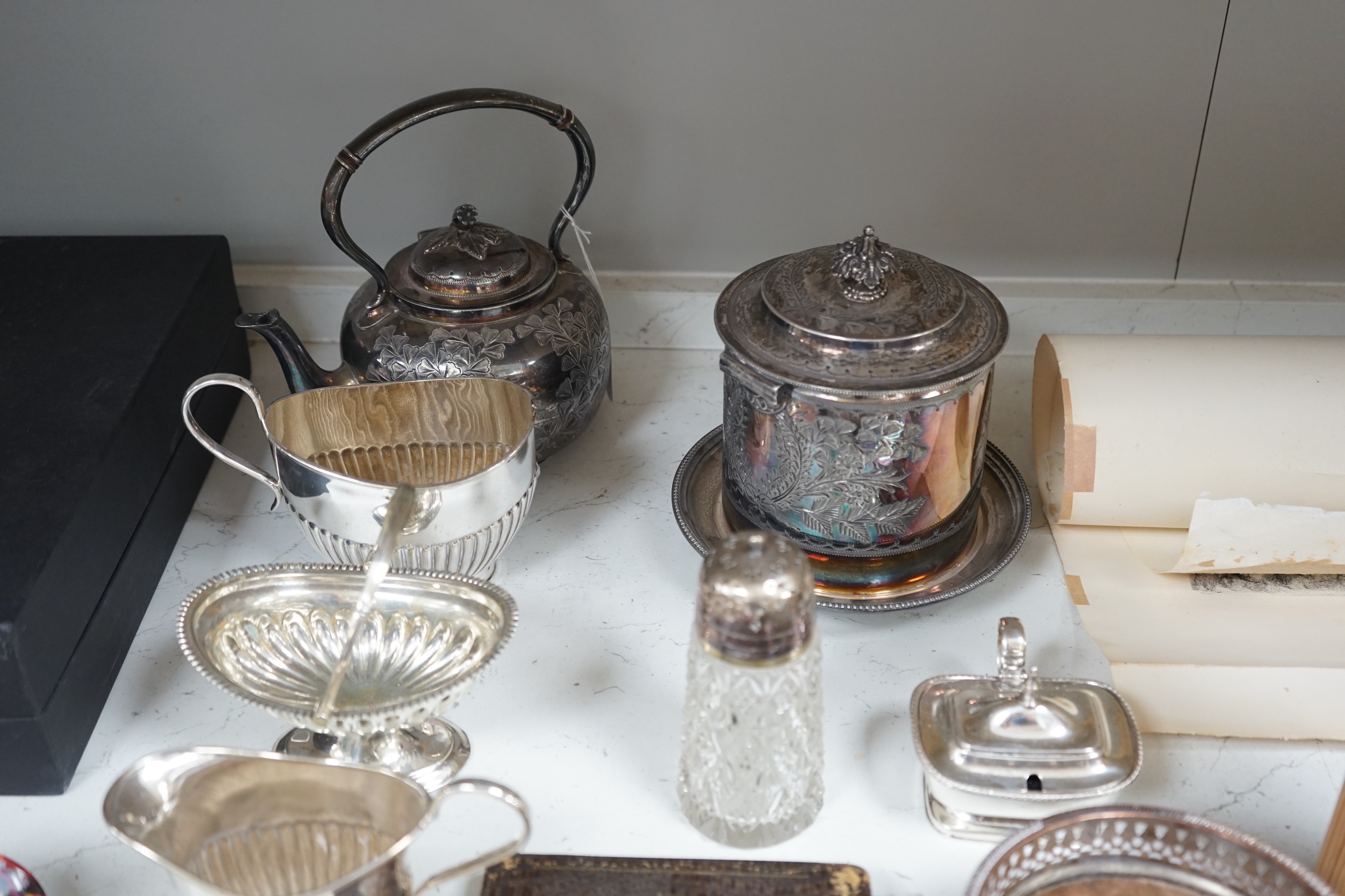 A collection of mixed silver plated wares, to include a pair of wine coasters, cream jug, novelty spoons, etc.
